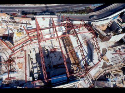 A birdseye view photo of The Anvil with lots of building equipment around and all the walls and flooring are white, but you can see a roofless auditorium as it being constructed