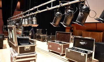 Tour boxes on The Anvil Stage, with a lighting bar lowered to focus the stage lighting