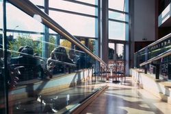 A low angle photo taken on the accessibility ramp in the stalls foyer looking out towards the large windows
