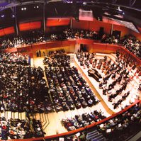 A photo from high up in The Anvil looking down on an audience and the stage while a classical concert is performed