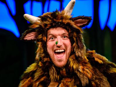 A man dressed as The Gruffalo with his mouth open