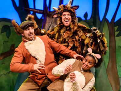 Three cast members from The Gruffalo performing on stage as animal characters from the book