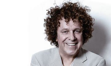 Leo Sayer smiling at the camera on a plain white background