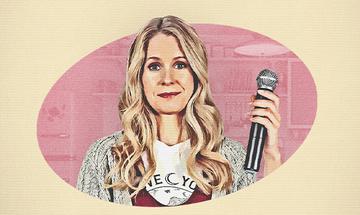 A cartoon of Lucy Beaumont in a pink circle holding a microphone
