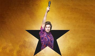Milton Jones in the middle of a black star, holding a microphone in the air, recreating the image used for the musical Hamilton