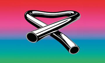Tubular Bells logo, a silver pipe that is bent into a triangular shape with the ends crossed over each other. it is on a background that is a gradient of red, pink, blue, and green