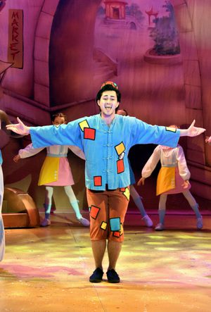 Aladdin with his hand held out to the side. He wears a blue and brown outfit