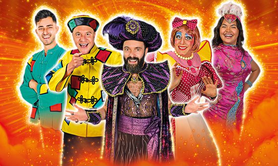 From left to right Kian Zomorodian dressed as Aladdin, Chris Pizzey dressed as Wishee Washee, James Mackenzie dressed as Abanazar, Nic Gibney dressed as Widow Twankey, and Natasha Cayabyab as Jasmine, they're all smiling on a sparkly orange background