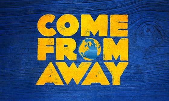 On a blue wooden background in yellow text reading 'Come From Away' with the O in From being a globe