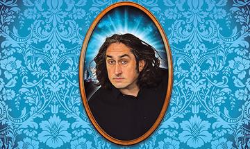Ross Noble in an oval, wooden frame with a light effect behind him. The background is a bright blue wallpaper with intricate, floral patterns