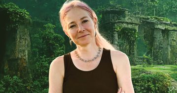 Alice Roberts in a black vest top against a background of an ancient city covered in greenery