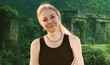 Alice Roberts in a black vest top against a background of an ancient city covered in greenery