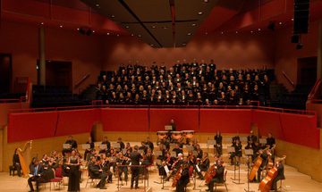 Basingstoke Symphony Orchestra sitting with their instruments.