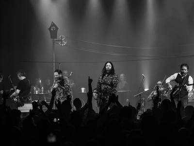 Taken from within the crowd you can see all five members of the band perform on stage.