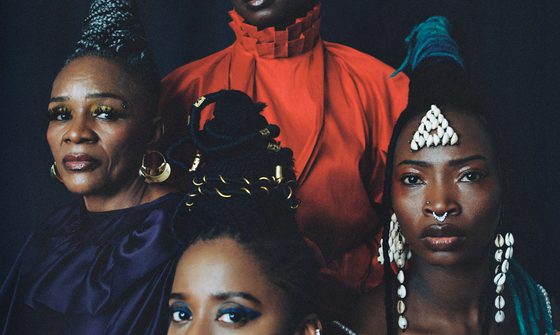 The band Les Amazones d’Afrique, four black women of various ages with striking make-up and hair, with bright tops