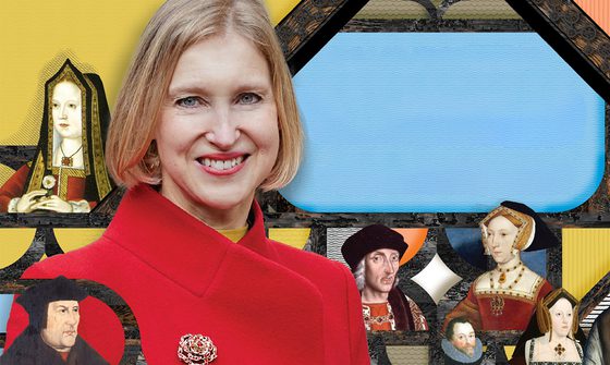 Tracy Borman is a red coat smiling at the camera on a colourful background with Tudor style woodwork surrounded by historical Tudor figures