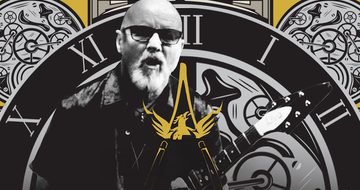 A black and white photo of a bald man with glasses and a beard playing guitar on a background of clock motifs with a yellow wishbone ash logo in front