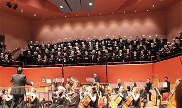 Basingstoke Choral Society performing in The Anvil with an orchestra below them