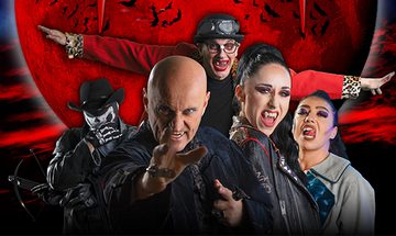 Five costumed individuals posing dramatically in front of a large red moon with bat silhouettes