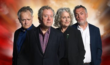Jon Culshaw, Jan Ravens, Lewis MacLeod, and Duncan Wisbey all stand together wearing suits and staring at the camera in a thoughtful manner