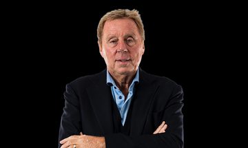 A photo of Harry Redknapp in a light blue shirt and dark blue jacket with his arms crossed on a black background