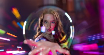a woman with a giant bubble on her hand in front of her