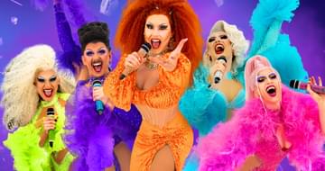 Five Drag Queens singing into microphones all wearing brightly coloured dresses