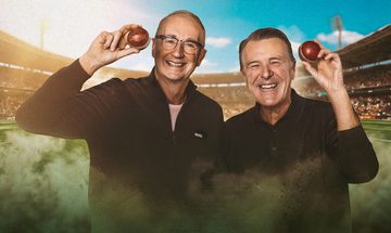 Jonathan Agnew and Phil Tufnell stood grinning and holding cricket balls by their heads with a cricket stadium behind