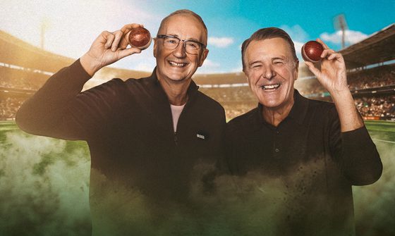Jonathan Agnew and Phil Tufnell stood grinning and holding cricket balls by their heads with a cricket stadium behind