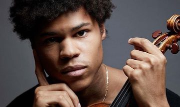a black man holding a violin