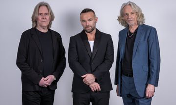 The members of Wet Wet Wet stood in a line wearing suits