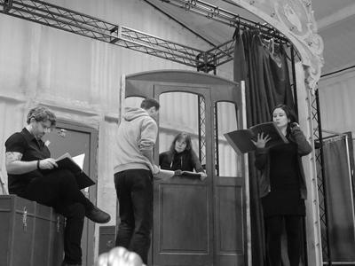 Black and white photo of four actors rehearsing for Houdini's Greatest Escape