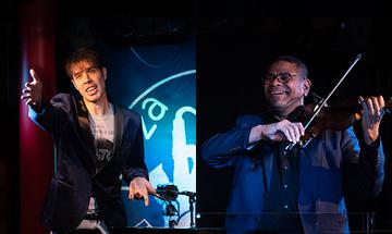 Split image of Ilario Ferrai, a slender italian man in a white graphic t-shirt and black blazer, on the left leaning out from the stage with his hand outstretched very dramatically. And Omar Puente a Cuban man with glasses and a black shirt with white blazer. playing a violin and smiling