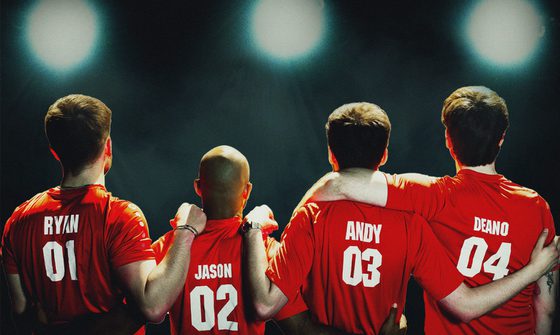 Four men, Ryan, Jason, Andy and Deano stand with their arms around each other, wearing red football shirts, as they look into the distance