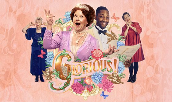 Wendi Peters in a pink dress and tiara singing with her arms held up, next to her is Matthew James Morrison in a white suit and black bowtie. Both are surrounded by pink and blue flowers and butterflies with 'Glorious' in large gold text under them on a pink background. Next to them are also two other female cast members, one looking lovingly and one with her fingers in her ears.