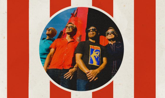 The four members of Haircut One Hundred are stood together dressed for summer. The image of them is a circle and around the circle are red and white vertical stripes.