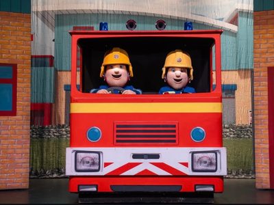 Fireman Sam and his friend in a firetruck