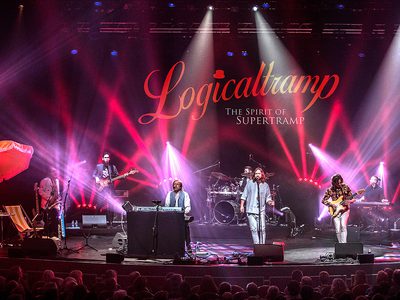 A band performing on stage with vibrant red and purple lights. "Logicaltramp: The Spirit of Supertramp" is displayed in the background