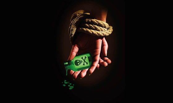 A black background with hands tied in rope holding a green bottle with a skull and cross bones on it