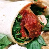meatballs in a wrap on a wooden board