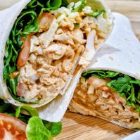 a cajun chicken wrap on a wooden board