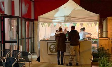 A Bit of a Do tent on The Terrace with people ordering food