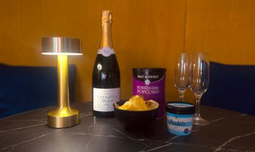 drinks and snacks laid out on a black and gold table